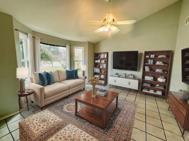 282 Spring River Dr, Martindale, TX 78655 - living area with light tile patterned floors, vaulted ceiling, and a ceiling fan