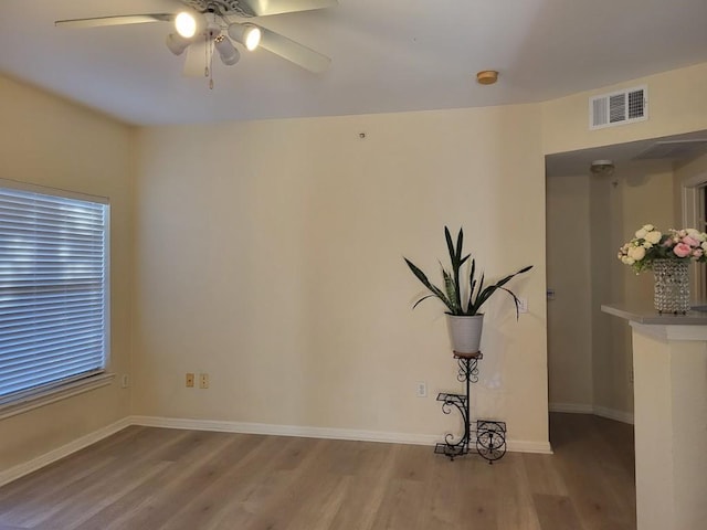 spare room featuring light hardwood / wood-style flooring and ceiling fan