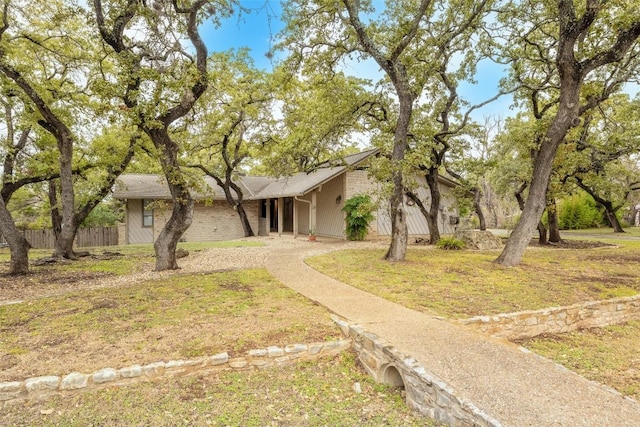 ranch-style home with a front lawn