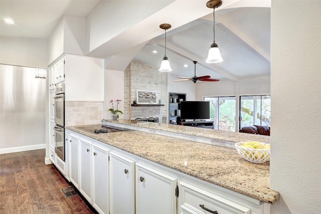 kitchen with pendant lighting, white cabinets, and light stone counters