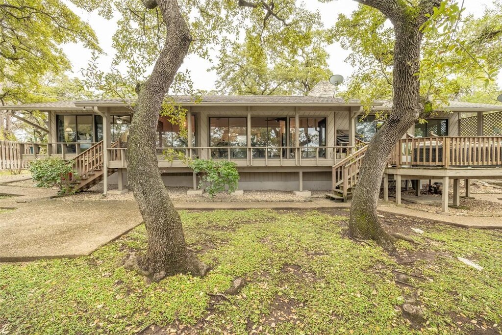 rear view of house featuring a sunroom