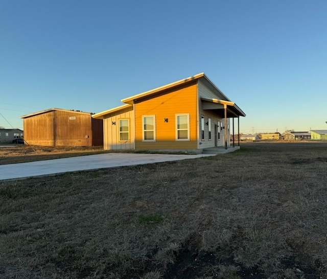 427 Pintail Loop, San Marcos, TX 78666 - back of house featuring board and batten siding and a yard