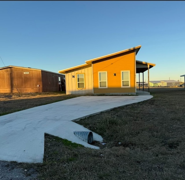 back of property featuring a lawn