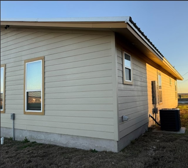 view of side of property with central air condition unit