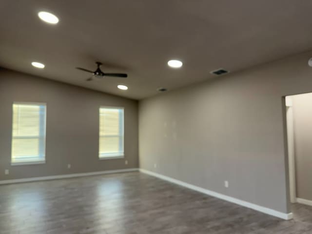 unfurnished room with hardwood / wood-style floors, ceiling fan, and lofted ceiling