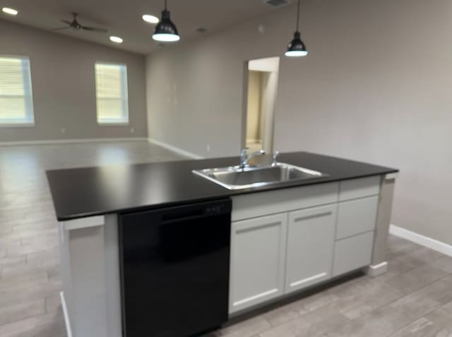 kitchen with lofted ceiling, white cabinets, sink, hanging light fixtures, and black dishwasher