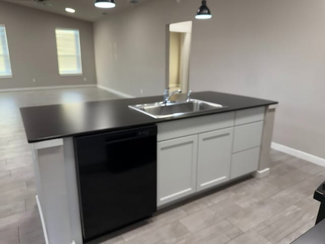 427 Pintail Loop, San Marcos, TX 78666 - kitchen with black dishwasher, white cabinetry, open floor plan, pendant lighting, and a center island with sink