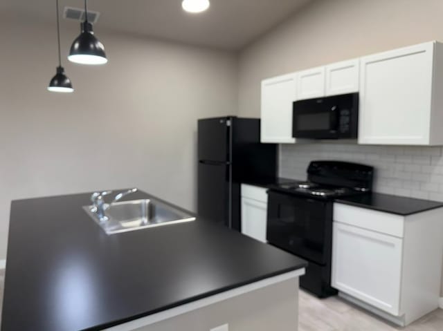 427 Pintail Loop, San Marcos, TX 78666 - kitchen with black appliances, dark countertops, white cabinets, decorative backsplash, and decorative light fixtures