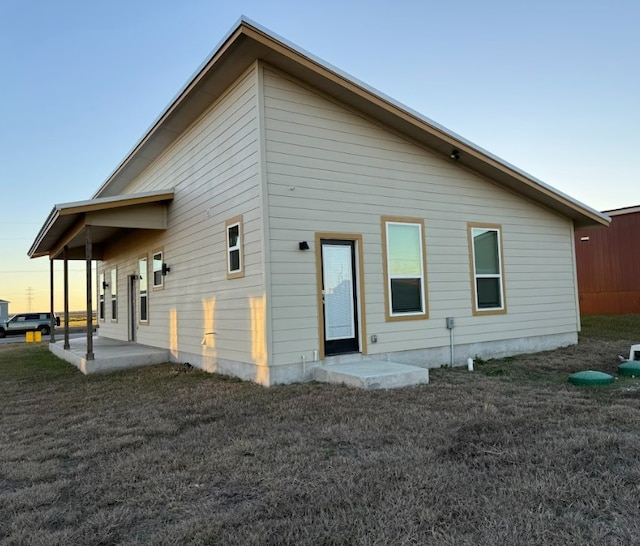 back house at dusk with a patio