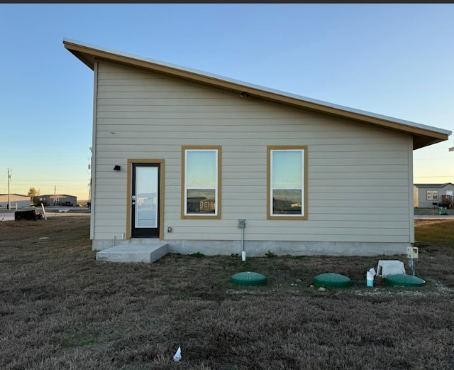 view of back house at dusk