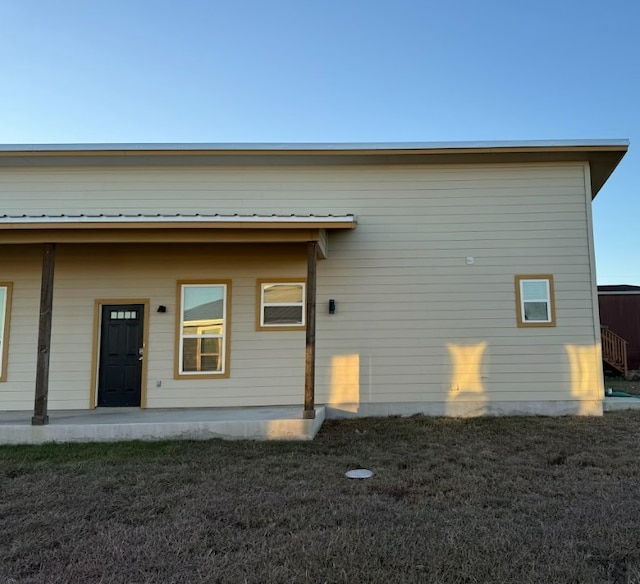 back of house with a lawn