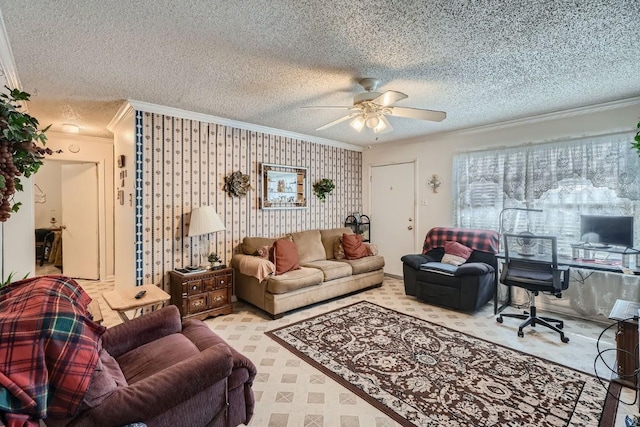 living room featuring a textured ceiling, ceiling fan, and crown molding