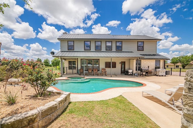 view of pool featuring an in ground hot tub and a patio area