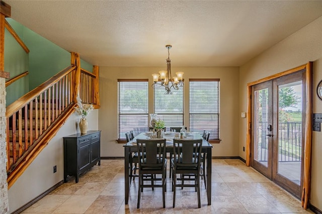 dining room with a notable chandelier and a textured ceiling