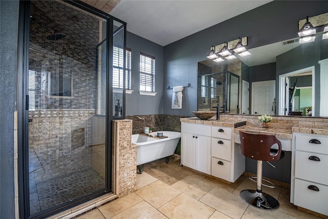 bathroom featuring tile patterned floors, vanity, and plus walk in shower