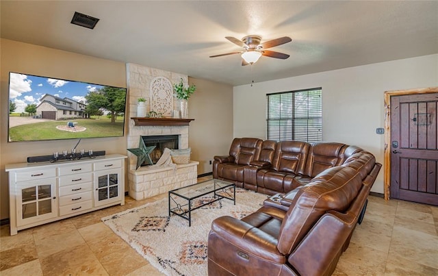 living room featuring a fireplace and ceiling fan