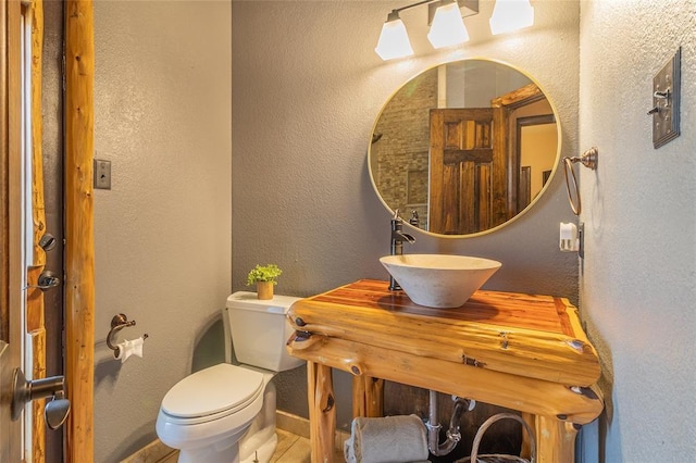 bathroom featuring toilet and sink