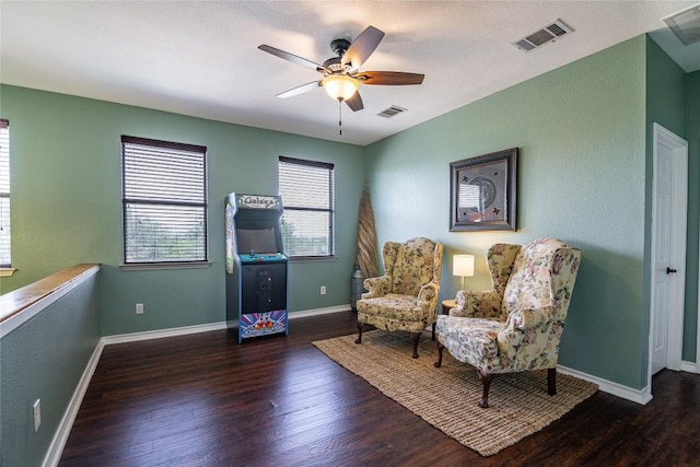 sitting room featuring dark hardwood / wood-style floors and ceiling fan