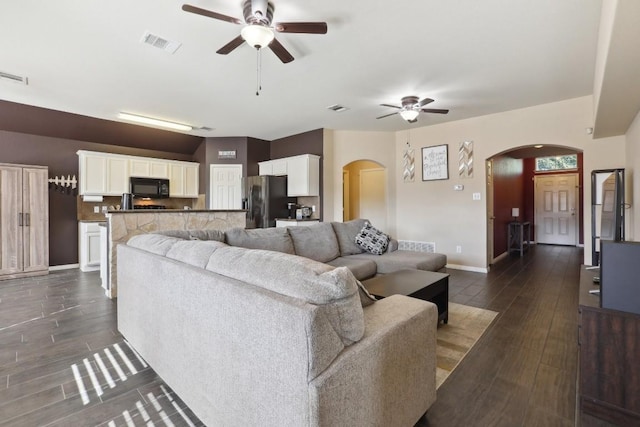 living room featuring dark hardwood / wood-style flooring and ceiling fan