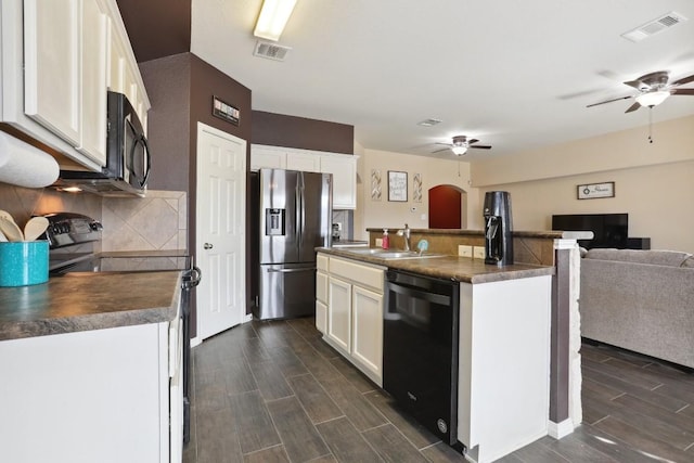 kitchen with stainless steel refrigerator with ice dispenser, a kitchen island with sink, electric range, dishwasher, and white cabinetry