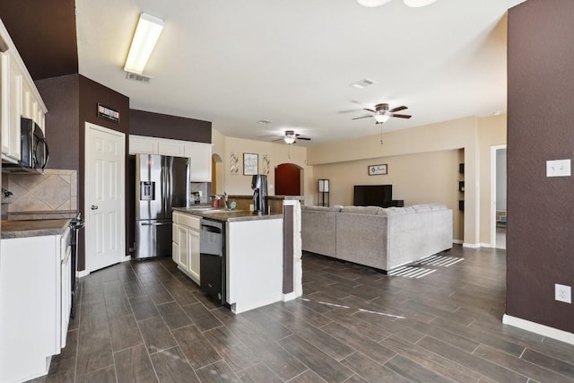 kitchen with black appliances, white cabinets, and an island with sink