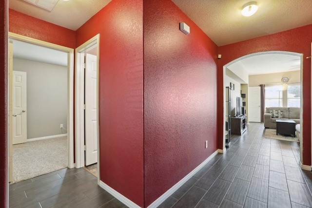 hallway featuring a textured ceiling