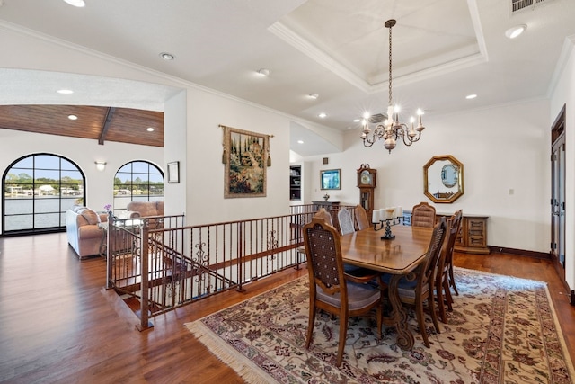 dining room featuring ornamental molding, vaulted ceiling, an inviting chandelier, and dark wood-type flooring