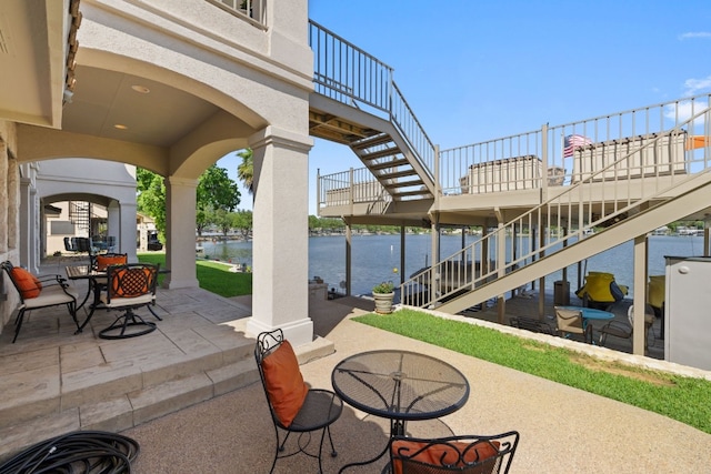 view of patio with a water view