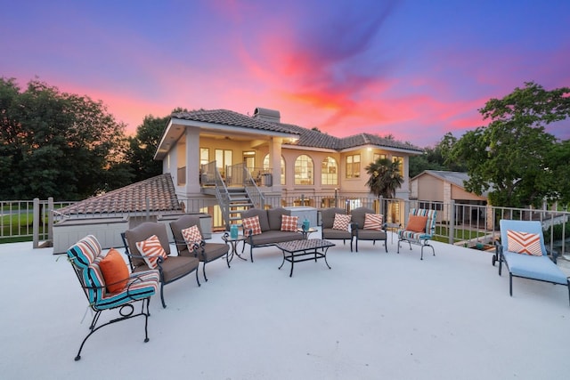 snow covered patio with an outdoor living space