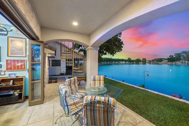 patio terrace at dusk with a water view