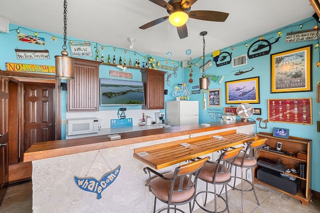 recreation room with light tile patterned floors and ceiling fan