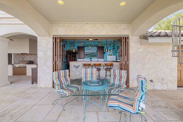 view of patio with a bar, area for grilling, and grilling area