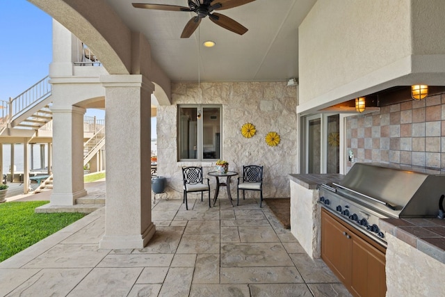 view of patio / terrace with area for grilling, ceiling fan, and grilling area