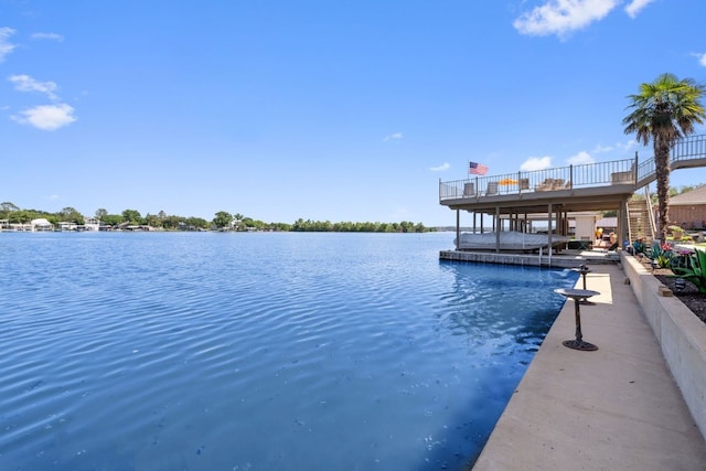 view of swimming pool featuring a dock and a water view