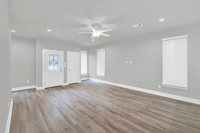 foyer entrance with light hardwood / wood-style floors and ceiling fan