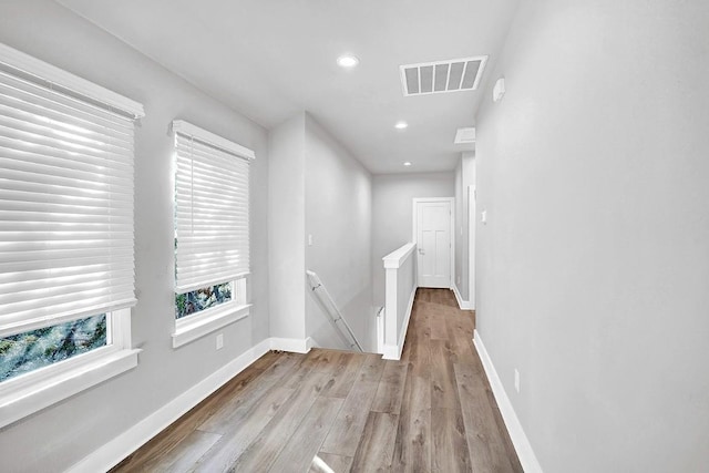 hallway with light hardwood / wood-style flooring