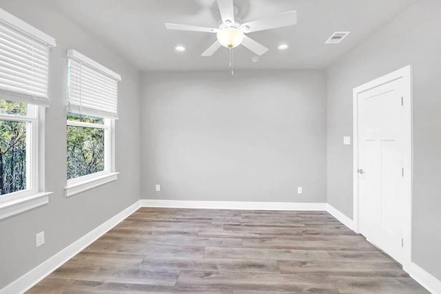 spare room featuring light hardwood / wood-style flooring and ceiling fan