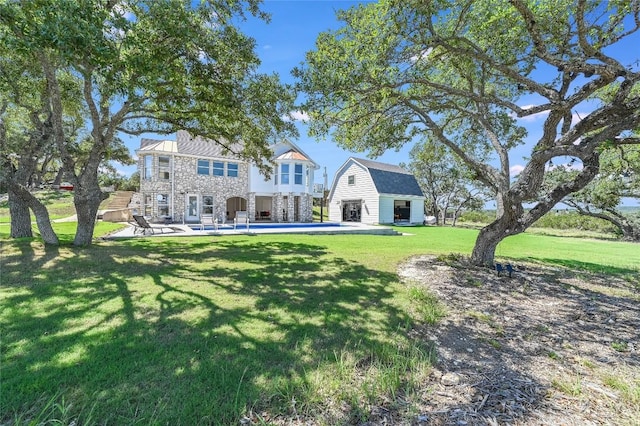 back of house featuring a yard and a patio area