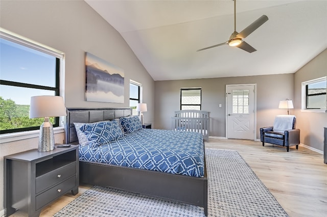 bedroom with light hardwood / wood-style floors, vaulted ceiling, and ceiling fan