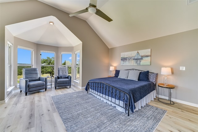 bedroom featuring ceiling fan, light hardwood / wood-style floors, and high vaulted ceiling