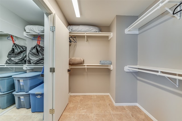 spacious closet featuring light tile patterned floors