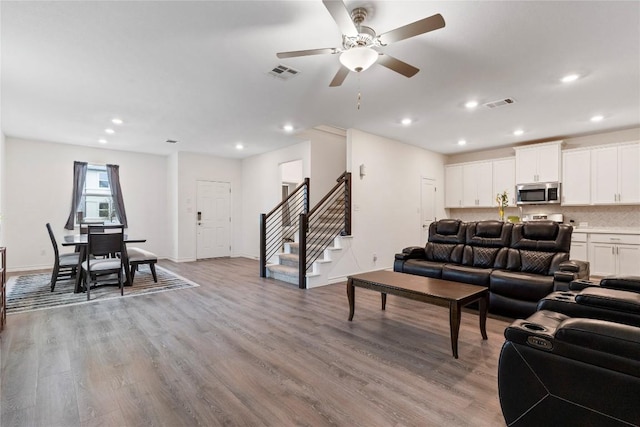 living room featuring ceiling fan and light wood-type flooring