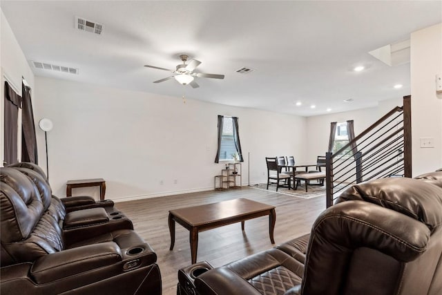 living room with ceiling fan and light wood-type flooring