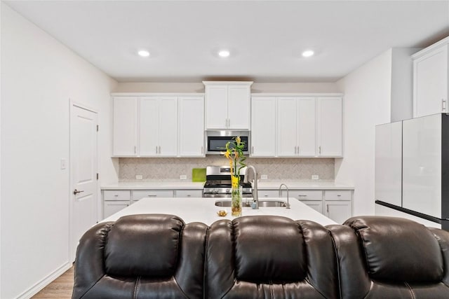 kitchen with white cabinetry, sink, and stainless steel appliances