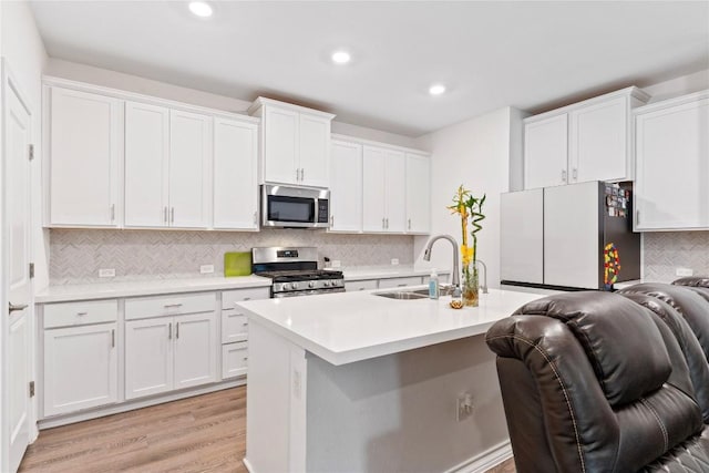 kitchen featuring white cabinetry, sink, and appliances with stainless steel finishes