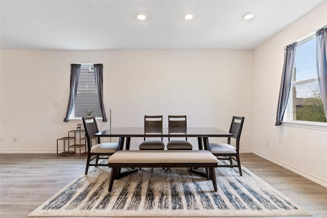 dining space with wood-type flooring