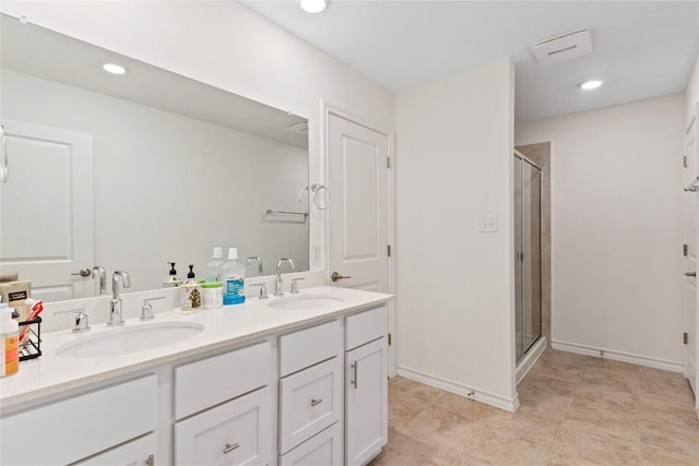 bathroom with vanity and a shower with shower door