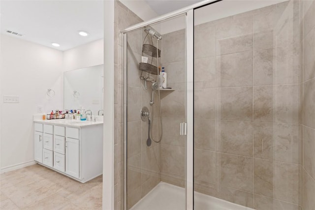 bathroom featuring vanity and a shower with shower door