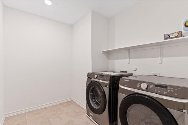 laundry room with separate washer and dryer and light tile patterned floors