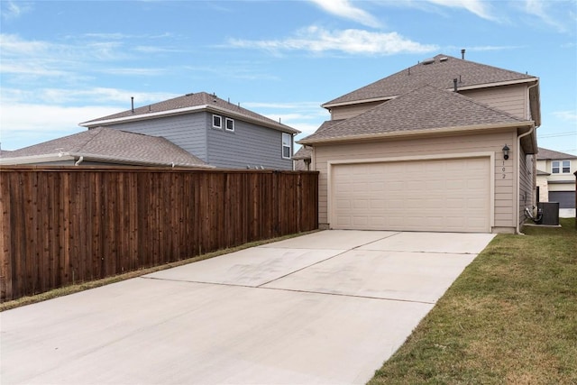 view of side of home with a lawn and a garage